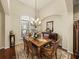 Formal dining room with decorative rug, chandelier, and plantation shutters for ample sunlight at 1336 Oakmont Dr, Winter Haven, FL 33884