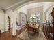 Open-concept formal dining room with tray ceilings, chandelier, and plantation shutters at 1336 Oakmont Dr, Winter Haven, FL 33884