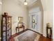 Traditional foyer with hardwood floors and a decorative rug leading to the glass front door at 1336 Oakmont Dr, Winter Haven, FL 33884