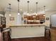Updated kitchen showcasing granite countertops, stainless steel appliances, and breakfast bar with pendant lighting at 1336 Oakmont Dr, Winter Haven, FL 33884