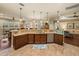 Bright and open kitchen with granite countertop island and stainless steel dishwasher seamlessly flowing into the living area at 1336 Oakmont Dr, Winter Haven, FL 33884