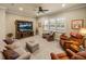 Comfortable living room with plush seating, entertainment center, and large window providing ample light at 1336 Oakmont Dr, Winter Haven, FL 33884