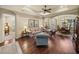 Open-concept formal living room with hardwood floors, tray ceilings, and decorative furniture at 1336 Oakmont Dr, Winter Haven, FL 33884