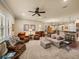 Comfortable living room with large windows, plush seating, and an open floor plan leading to the dining area at 1336 Oakmont Dr, Winter Haven, FL 33884