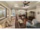 Open-concept living room featuring hardwood floors, tray ceilings, and decorative furniture at 1336 Oakmont Dr, Winter Haven, FL 33884