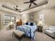 Comfortable bedroom with ceiling fans, natural light from shuttered windows and tasteful decor at 1336 Oakmont Dr, Winter Haven, FL 33884