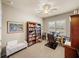 Home office featuring a ceiling fan, a window with shutters, and a large bookcase at 1336 Oakmont Dr, Winter Haven, FL 33884