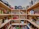 Well-organized walk-in pantry with natural wood shelving filled with various food items and appliances at 1336 Oakmont Dr, Winter Haven, FL 33884