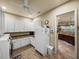 View of a pantry with white cabinets, contrasting countertops, white refrigerator, and tiled floor at 1336 Oakmont Dr, Winter Haven, FL 33884