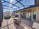 Relaxing screened patio with brick floor, outdoor kitchen, ceiling fan and comfortable seating at 1336 Oakmont Dr, Winter Haven, FL 33884