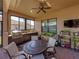 Covered patio with brick flooring, ceiling fan, grill, and potted plants for outdoor relaxation and entertainment at 1336 Oakmont Dr, Winter Haven, FL 33884