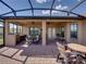 Large patio with outdoor kitchen, seating, and dual ceiling fans, ideal for entertaining at 1336 Oakmont Dr, Winter Haven, FL 33884