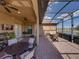 Spacious patio with a screened enclosure and serene lake view, perfect for outdoor enjoyment at 1336 Oakmont Dr, Winter Haven, FL 33884