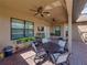 Covered patio with ceiling fans, outdoor seating, and brick flooring offers a relaxing space at 1336 Oakmont Dr, Winter Haven, FL 33884