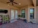 Enclosed patio with brick flooring, a ceiling fan, a flat-screen TV, and an array of potted plants at 1336 Oakmont Dr, Winter Haven, FL 33884