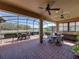 Enclosed patio with brick flooring, ceiling fans, outdoor kitchen, grill, and a scenic waterfront view at 1336 Oakmont Dr, Winter Haven, FL 33884