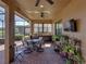 Covered patio featuring brick flooring, outdoor kitchen, a grill, seating and potted plants on a tiered stand at 1336 Oakmont Dr, Winter Haven, FL 33884