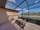 Enjoy outdoor dining in this screened patio with lovely lake view at 1336 Oakmont Dr, Winter Haven, FL 33884