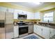 Modern kitchen with stainless steel appliances, granite countertops, and ample cabinet space at 139 Jackson St, Lake Wales, FL 33859