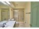 Neutral-toned bathroom features a shower with glass door and functional fixtures at 1412 Covington Ct, Lake Wales, FL 33853