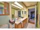 Bathroom featuring dual sinks and a spacious vanity with wood cabinets at 1412 Covington Ct, Lake Wales, FL 33853