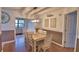 Cozy dining area with a rustic table, pendant lighting, and open access to other rooms at 1412 Covington Ct, Lake Wales, FL 33853