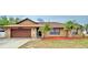 Charming single-story home with a stone facade, mature landscaping, and a two-car garage at 1412 Covington Ct, Lake Wales, FL 33853