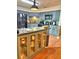 Stylish kitchen featuring gray cabinets, black appliances, a mosaic backsplash, and an island at 1412 Covington Ct, Lake Wales, FL 33853