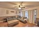 Comfortable living room featuring a large sectional sofa, coffee table, and bright windows at 1412 Covington Ct, Lake Wales, FL 33853