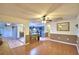 Spacious living room with wood floors and neutral decor, flowing into the kitchen area at 1412 Covington Ct, Lake Wales, FL 33853