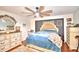 Comfortable main bedroom featuring stylish decor, soft lighting, and a ceiling fan at 1412 Covington Ct, Lake Wales, FL 33853