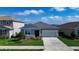 Charming home surrounded by lush greenery and a serene lake nearby, creating a tranquil setting at 153 Summershore Dr, Auburndale, FL 33823