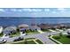 Aerial view of a neighborhood featuring lakefront homes, private docks, and street access at 153 Summershore Dr, Auburndale, FL 33823