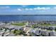 Stunning aerial view of a lakeside community, showcasing homes with waterfront access and manicured lawns at 153 Summershore Dr, Auburndale, FL 33823