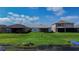 Beautiful backyard view of single-Gathering homes with screened-in patios and well-maintained green lawn at 153 Summershore Dr, Auburndale, FL 33823
