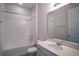 Bathroom with shower and tub, white vanity, and white-tiled walls at 153 Summershore Dr, Auburndale, FL 33823