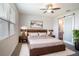 Cozy bedroom with a ceiling fan, sliding door to bathroom, and a wooden platform bed at 153 Summershore Dr, Auburndale, FL 33823