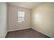 Cozy bedroom features carpet flooring, neutral paint, and a window with blinds for natural light at 153 Summershore Dr, Auburndale, FL 33823