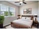 Inviting bedroom featuring a wooden bed frame, soft rug, and natural light from the window at 153 Summershore Dr, Auburndale, FL 33823