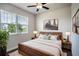 Bright bedroom featuring a ceiling fan, a large window, and a comfortable bed at 153 Summershore Dr, Auburndale, FL 33823