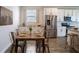 Cozy dining area features a rustic wood table, stylish metal chairs, and abundant natural light at 153 Summershore Dr, Auburndale, FL 33823