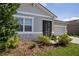 Exterior of home with stone accents, front yard landscaping, and a two car garage at 153 Summershore Dr, Auburndale, FL 33823