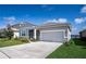 Inviting home with gray stucco, stone accents, screened entry and a two-car garage, perfect for any Gathering at 153 Summershore Dr, Auburndale, FL 33823