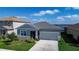 Attractive home featuring a gray stucco exterior, stone accents, screened entry and a two-car garage at 153 Summershore Dr, Auburndale, FL 33823