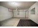 Spacious two-car garage featuring a white garage door and concrete flooring at 153 Summershore Dr, Auburndale, FL 33823