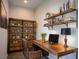 Functional home office with a rustic wood desk, shelving, and plenty of storage space at 153 Summershore Dr, Auburndale, FL 33823