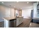 Kitchen featuring an island with white cabinets, granite countertop and stainless steel appliances at 153 Summershore Dr, Auburndale, FL 33823