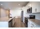 Modern kitchen with white cabinets, stainless steel appliances, and an island at 153 Summershore Dr, Auburndale, FL 33823