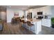 Bright, modern kitchen with large center island, seating, stainless steel appliances, and adjacent dining area at 153 Summershore Dr, Auburndale, FL 33823