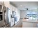Bright kitchen with stainless steel appliances, white cabinetry, and a view of the lake at 153 Summershore Dr, Auburndale, FL 33823